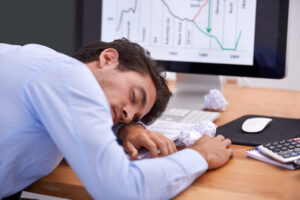 Is 6 hours of sleep enough - pic of man sleeping at work because it isn't